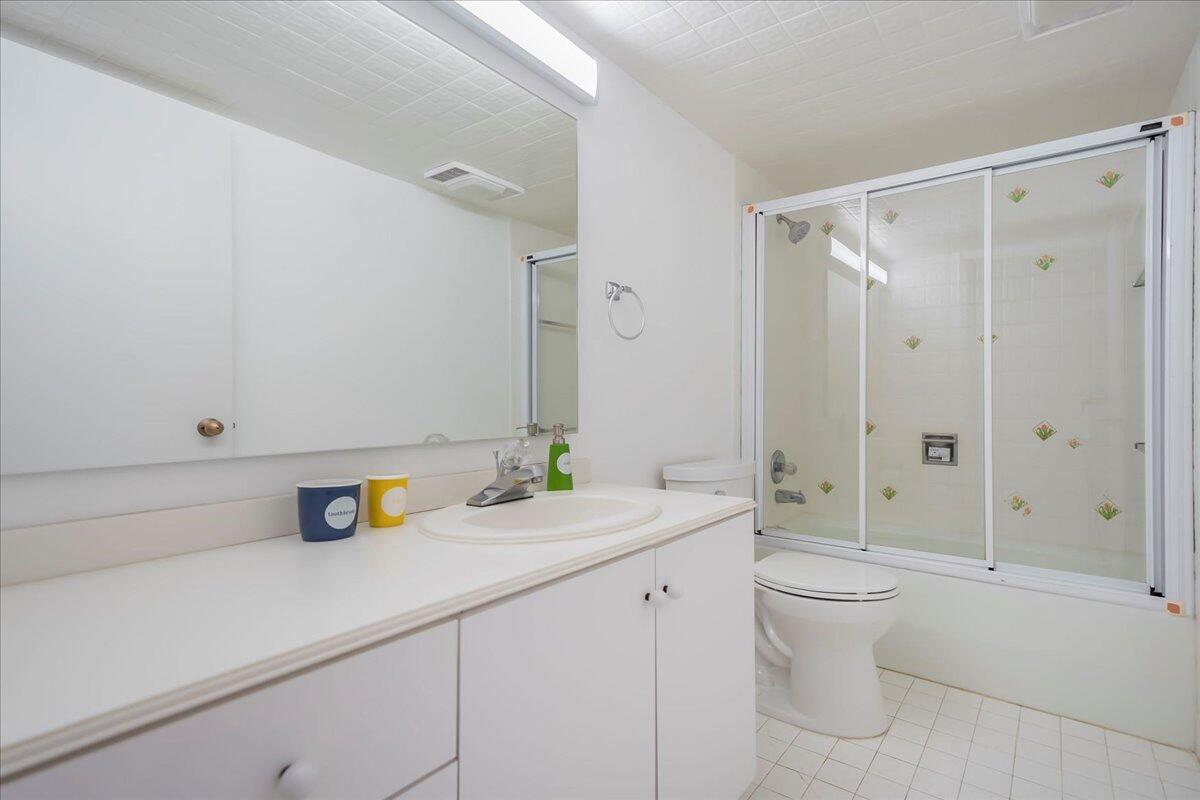4201 North Ocean Boulevard, Unit 203 Boca Raton, FL 33431 - Photo 11 of 54 a bathroom with a sink a toilet and shower