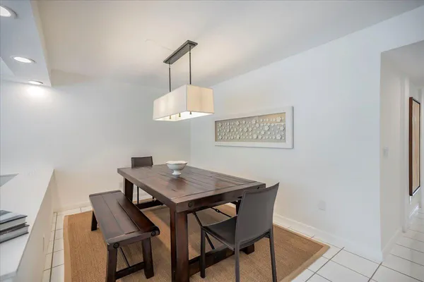 a view of a dining room with a table and chairs