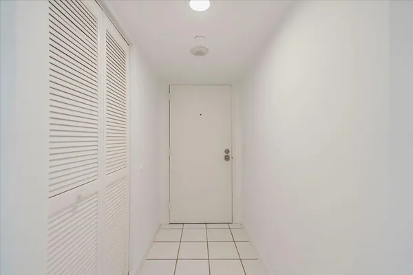 a spacious bedroom with two beds and large windows