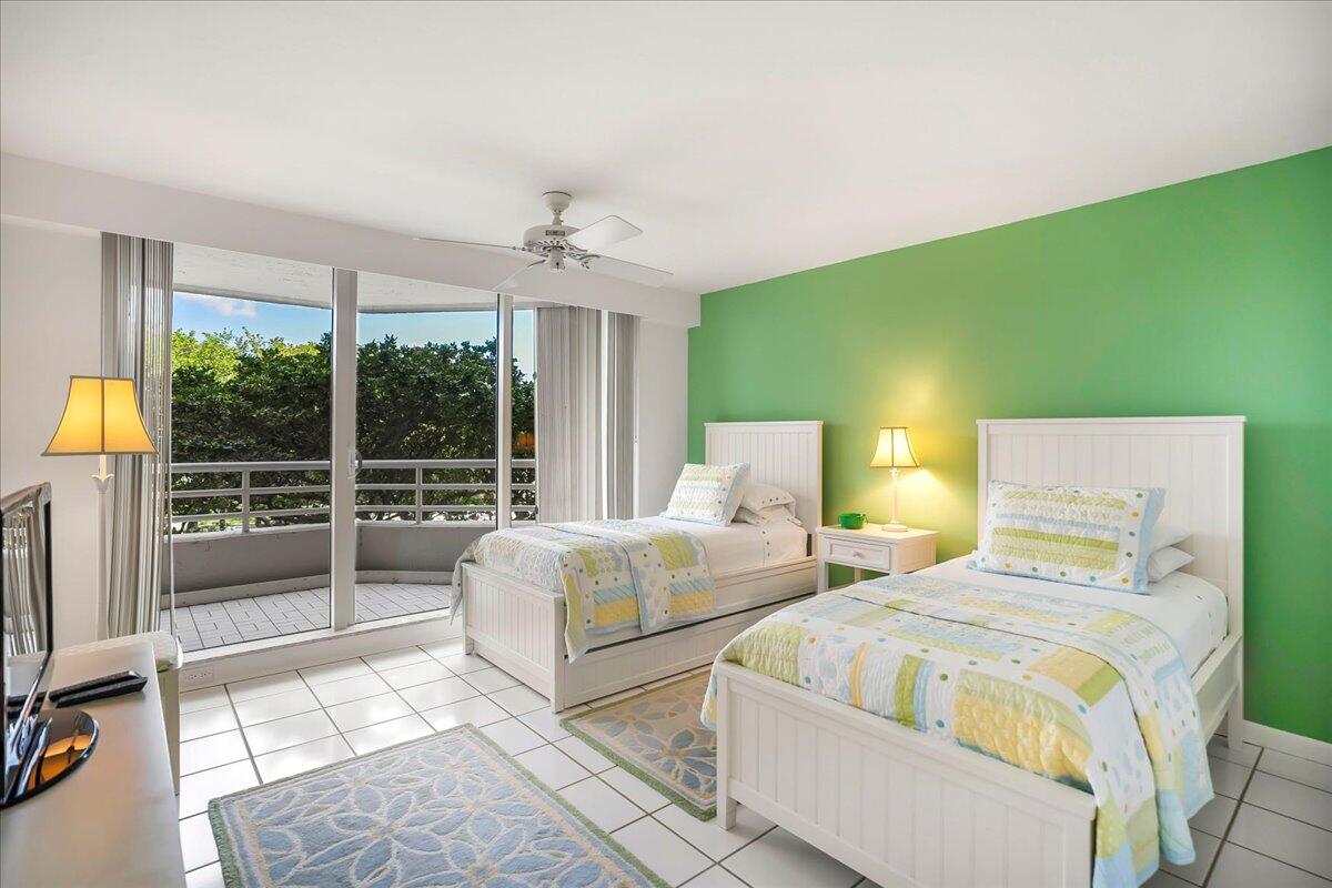 4201 North Ocean Boulevard, Unit 203 Boca Raton, FL 33431 - Photo 16 of 54 a spacious bedroom with two beds and large windows