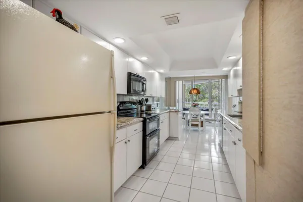 a kitchen with sink cabinets and window