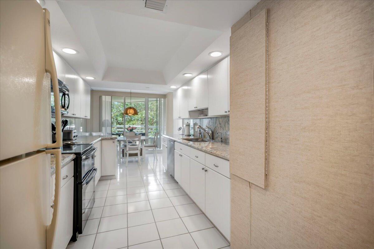 4201 North Ocean Boulevard, Unit 203 Boca Raton, FL 33431 - Photo 20 of 54 a kitchen with sink cabinets and window