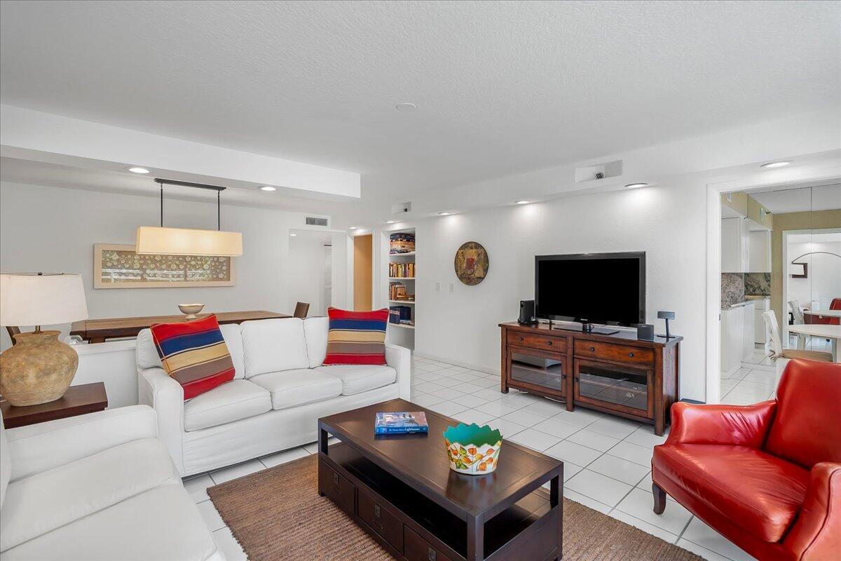 4201 North Ocean Boulevard, Unit 203 Boca Raton, FL 33431 - Photo 25 of 54 a living room with furniture and a flat screen tv