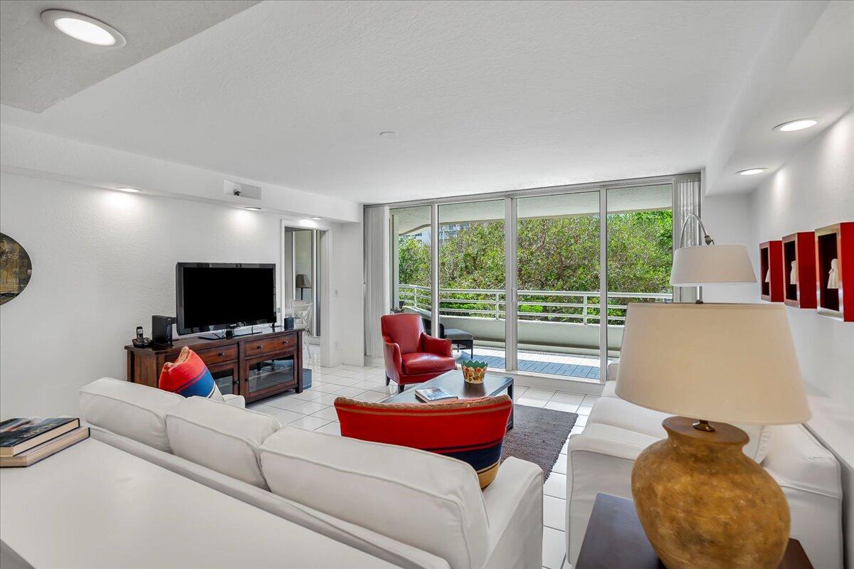 4201 North Ocean Boulevard, Unit 203 Boca Raton, FL 33431 - Photo 26 of 54 a living room with furniture and a flat screen tv