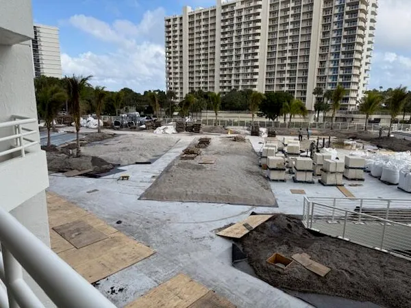 a view of a swimming pool with a patio and ocean view
