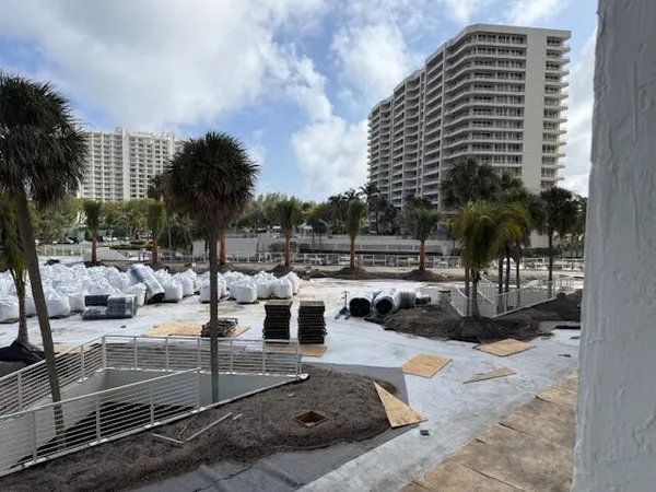 a view of swimming pool with outdoor seating and lake view