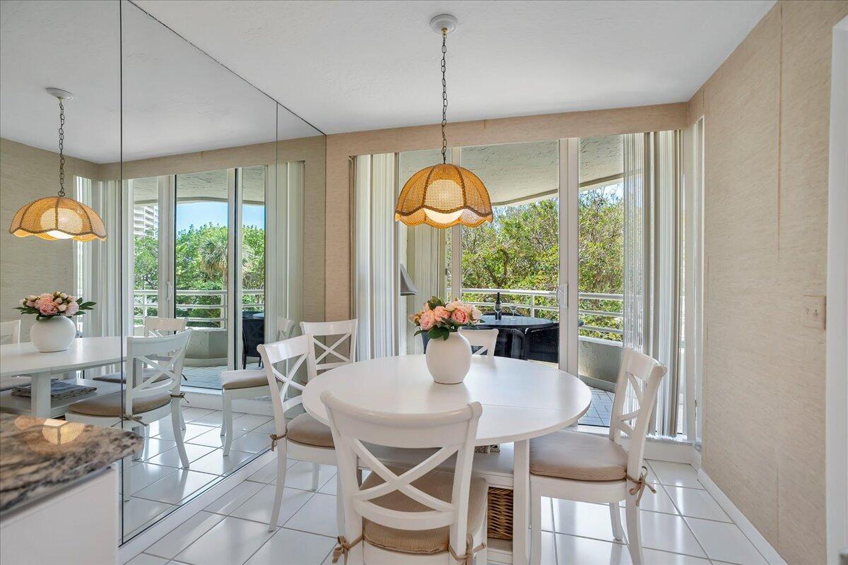 4201 North Ocean Boulevard, Unit 203 Boca Raton, FL 33431 - Photo 5 of 54 a view of a dining room with furniture large windows and wooden floor