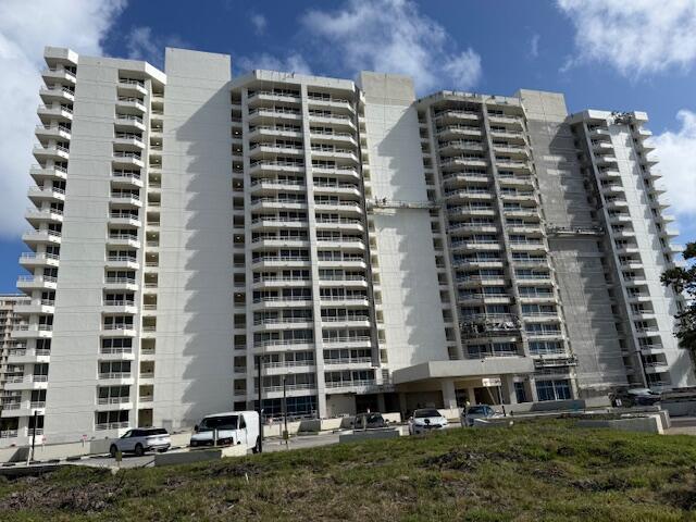 4201 North Ocean Boulevard, Unit 203 Boca Raton, FL 33431 - Photo 52 of 54 a front view of a building with a yard