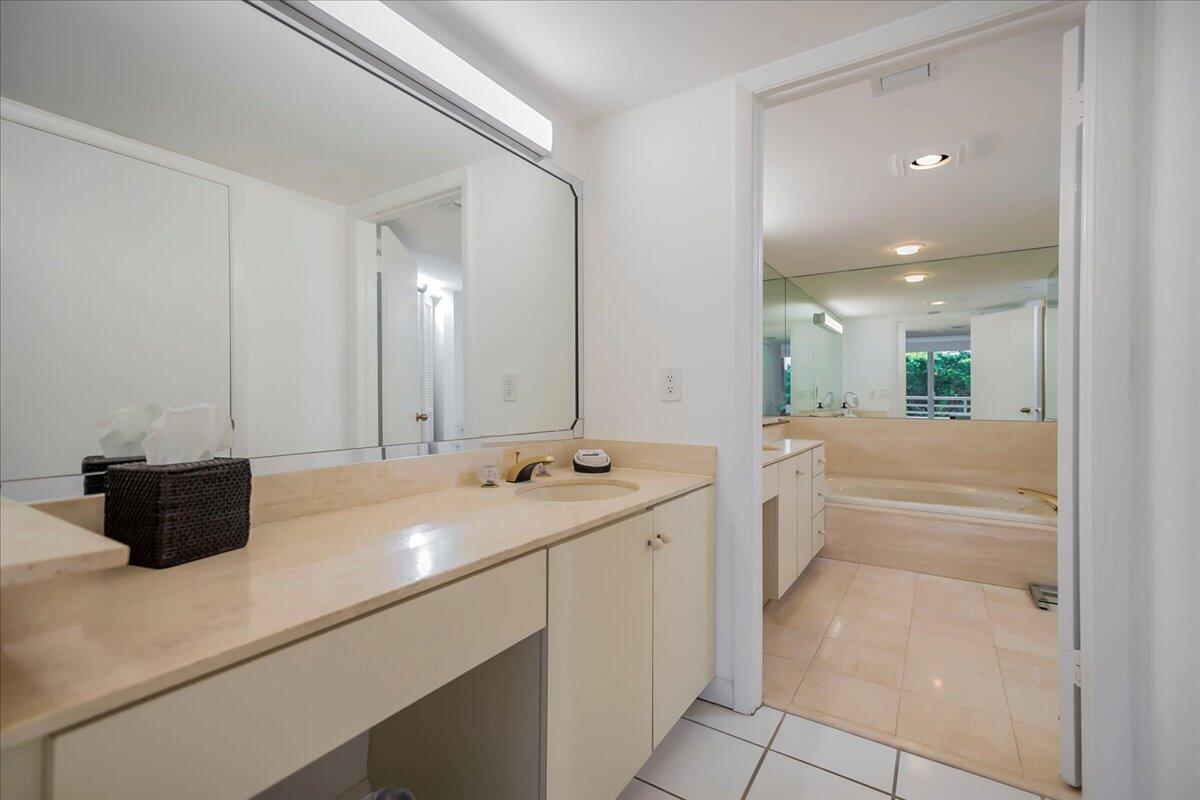 4201 North Ocean Boulevard, Unit 203 Boca Raton, FL 33431 - Photo 6 of 54 a bathroom with a double vanity sink and mirror