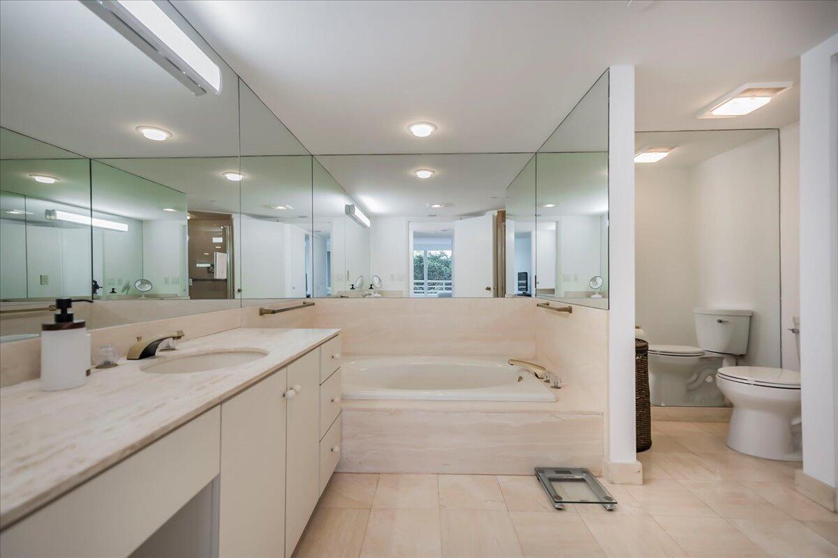 4201 North Ocean Boulevard, Unit 203 Boca Raton, FL 33431 - Photo 8 of 54 a bathroom with a granite countertop sink mirror and toilet