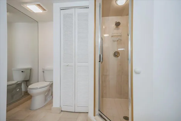 a bathroom with a shower and a toilet