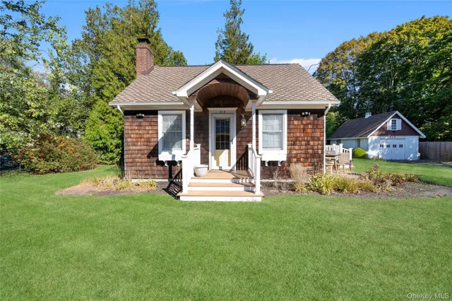 a view of a house with a yard and sitting area