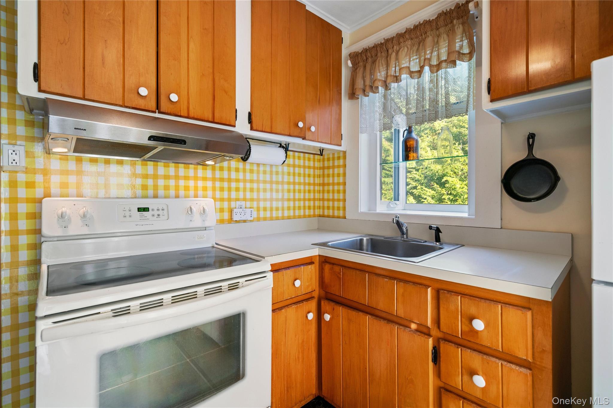 313 Forest Road West Mastic Beach, NY 11951 - Photo 11 of 19 a kitchen with stainless steel appliances granite countertop a sink a stove and a microwave