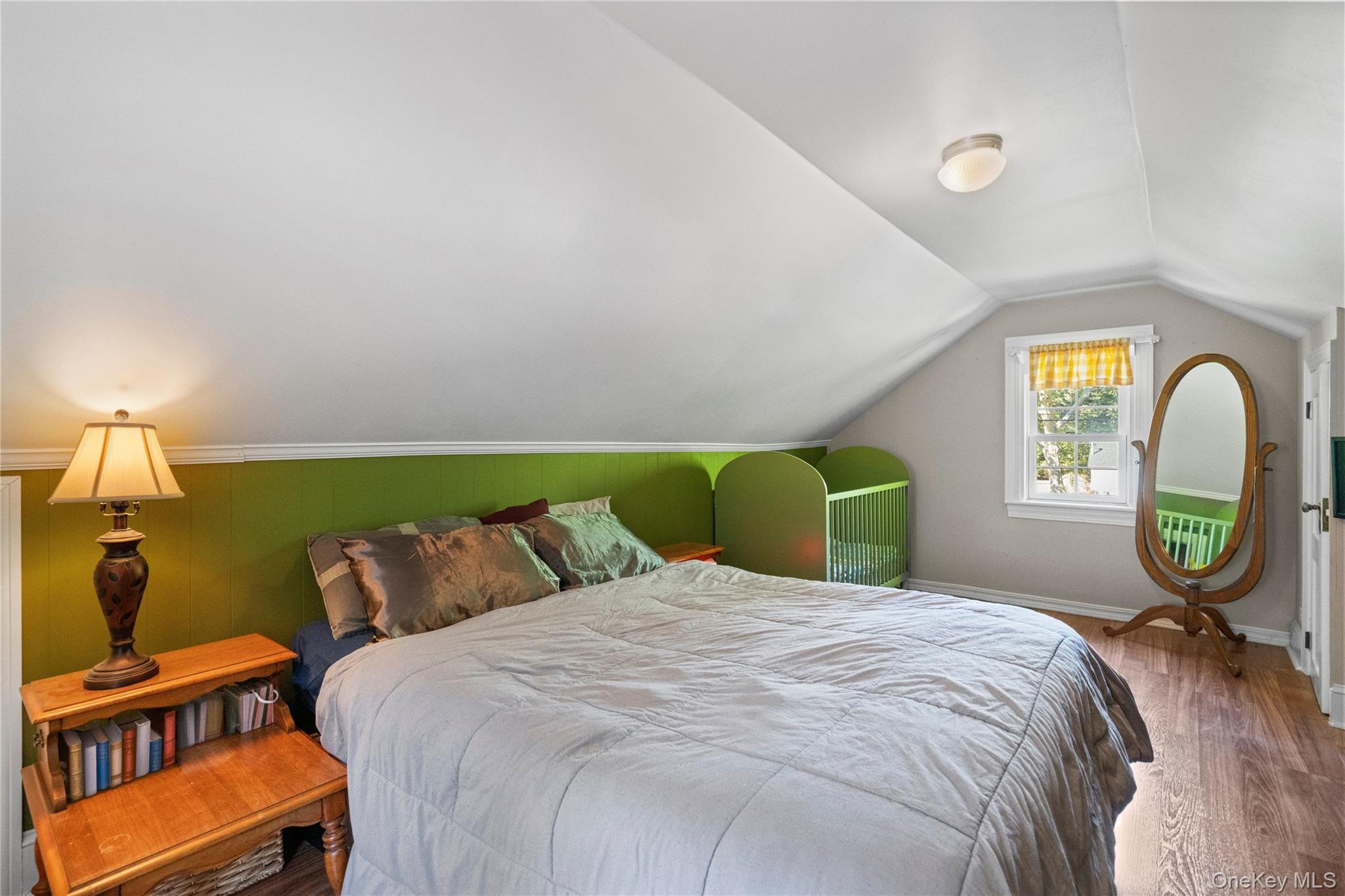 313 Forest Road West Mastic Beach, NY 11951 - Photo 13 of 19 a bedroom with a bed a dresser and a window
