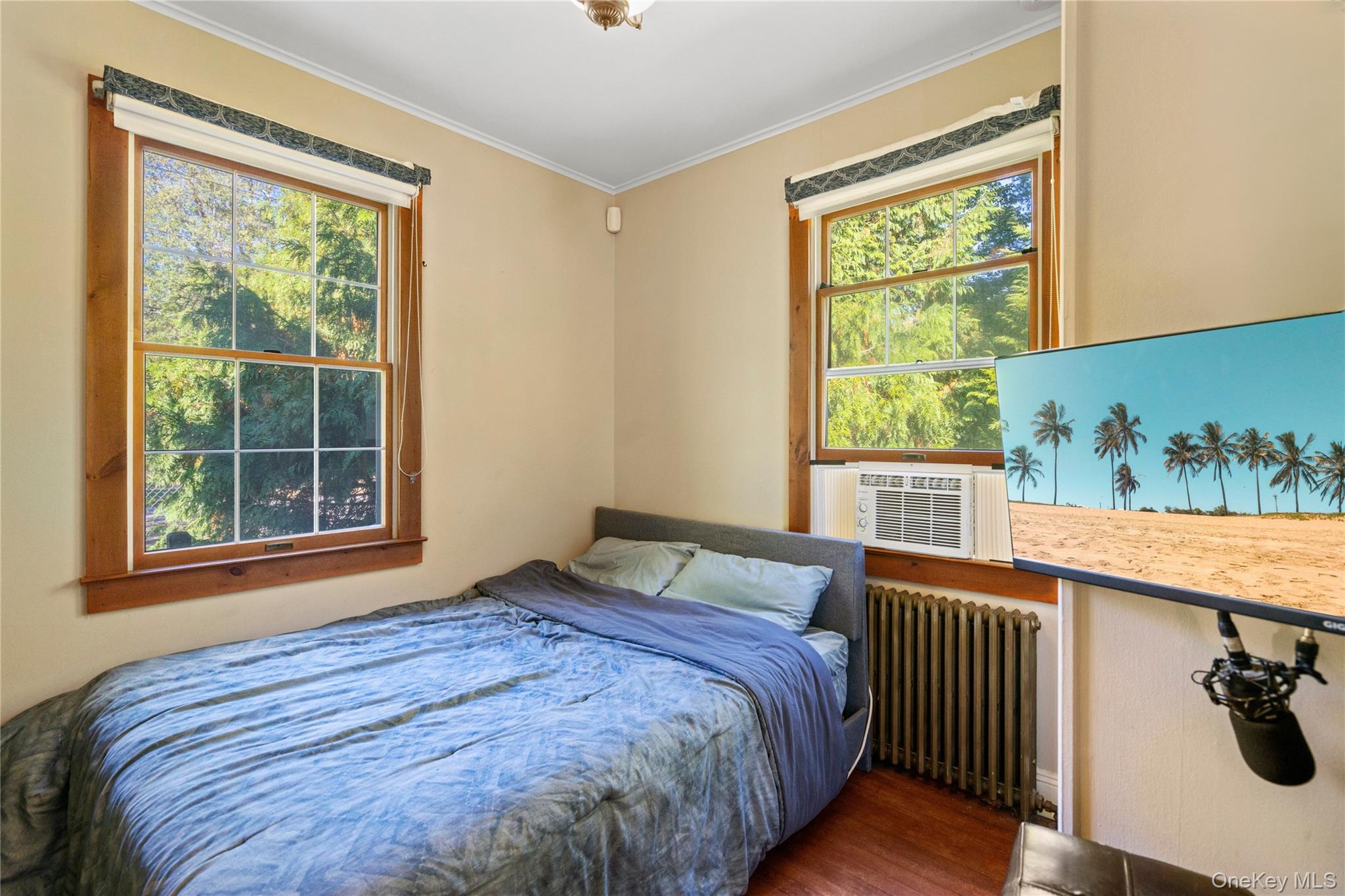 313 Forest Road West Mastic Beach, NY 11951 - Photo 14 of 19 a bedroom with a bed and a window
