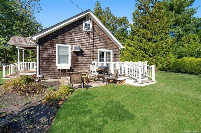 a backyard of a house with table and chairs