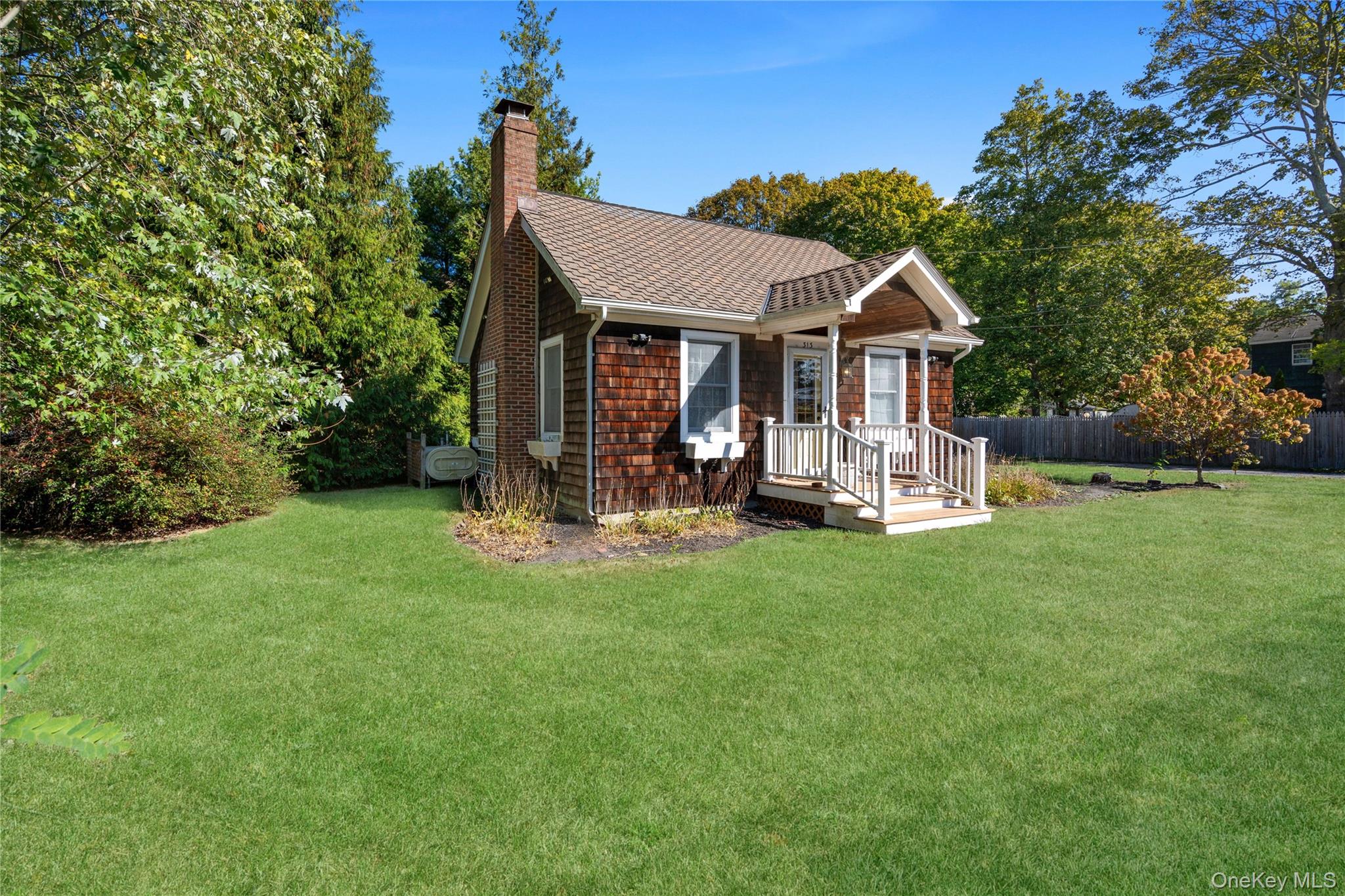 313 Forest Road West Mastic Beach, NY 11951 - Photo 2 of 19 a view of a house with backyard and a tree