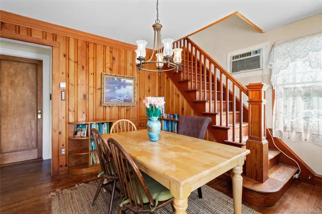 a dining room with furniture window and wooden floor