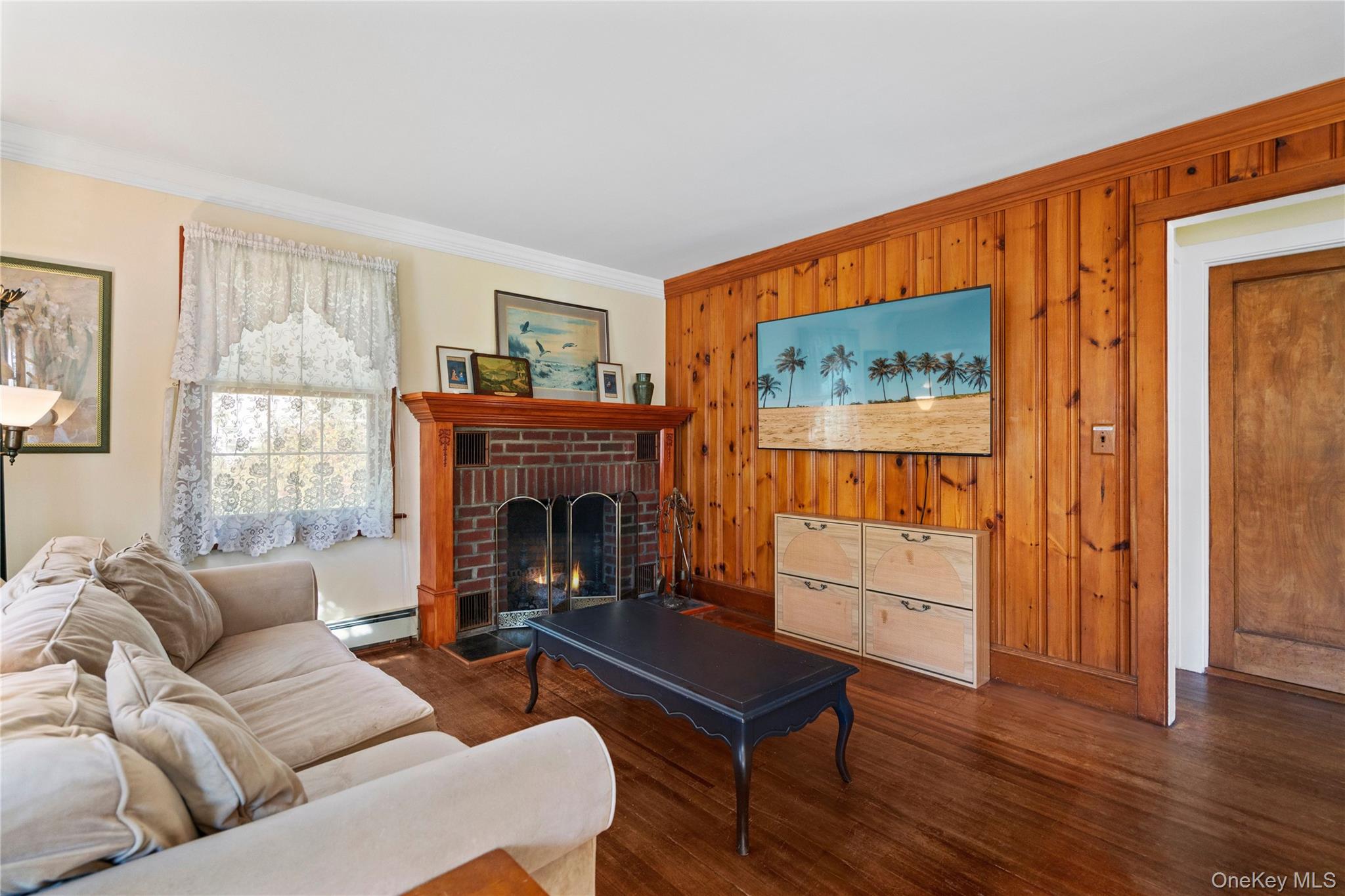 313 Forest Road West Mastic Beach, NY 11951 - Photo 6 of 19 a living room with furniture a flat screen tv and a fireplace
