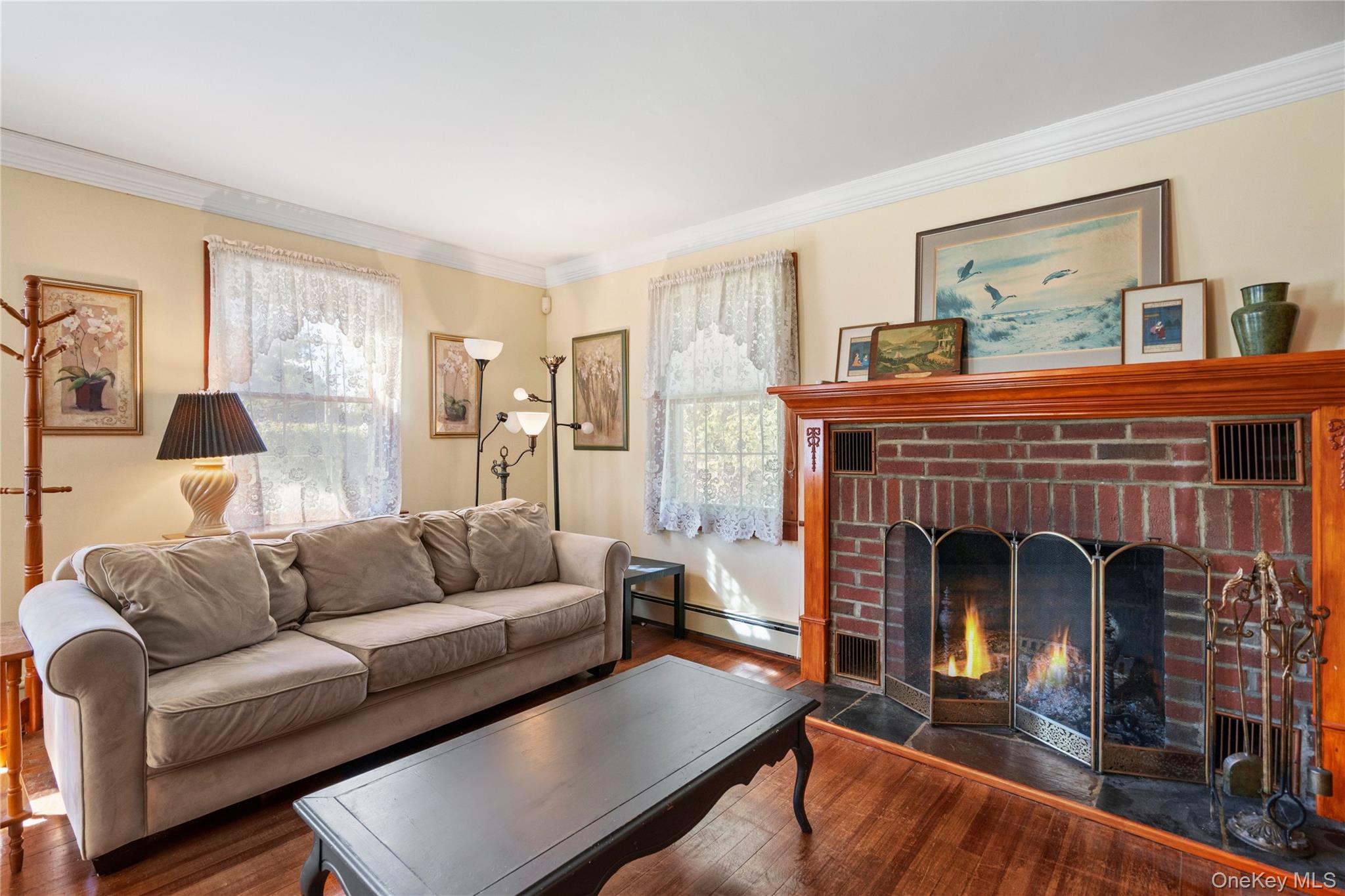 313 Forest Road West Mastic Beach, NY 11951 - Photo 7 of 19 a living room with furniture and a fireplace