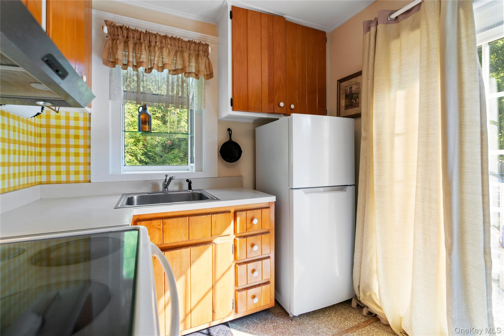 313 Forest Road West Mastic Beach, NY 11951 - Photo 9 of 19 a kitchen with a refrigerator a stove and a window