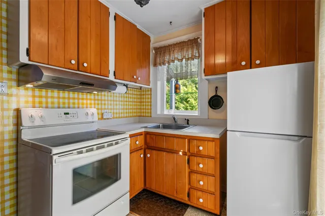 a kitchen with stainless steel appliances granite countertop a refrigerator sink and cabinets
