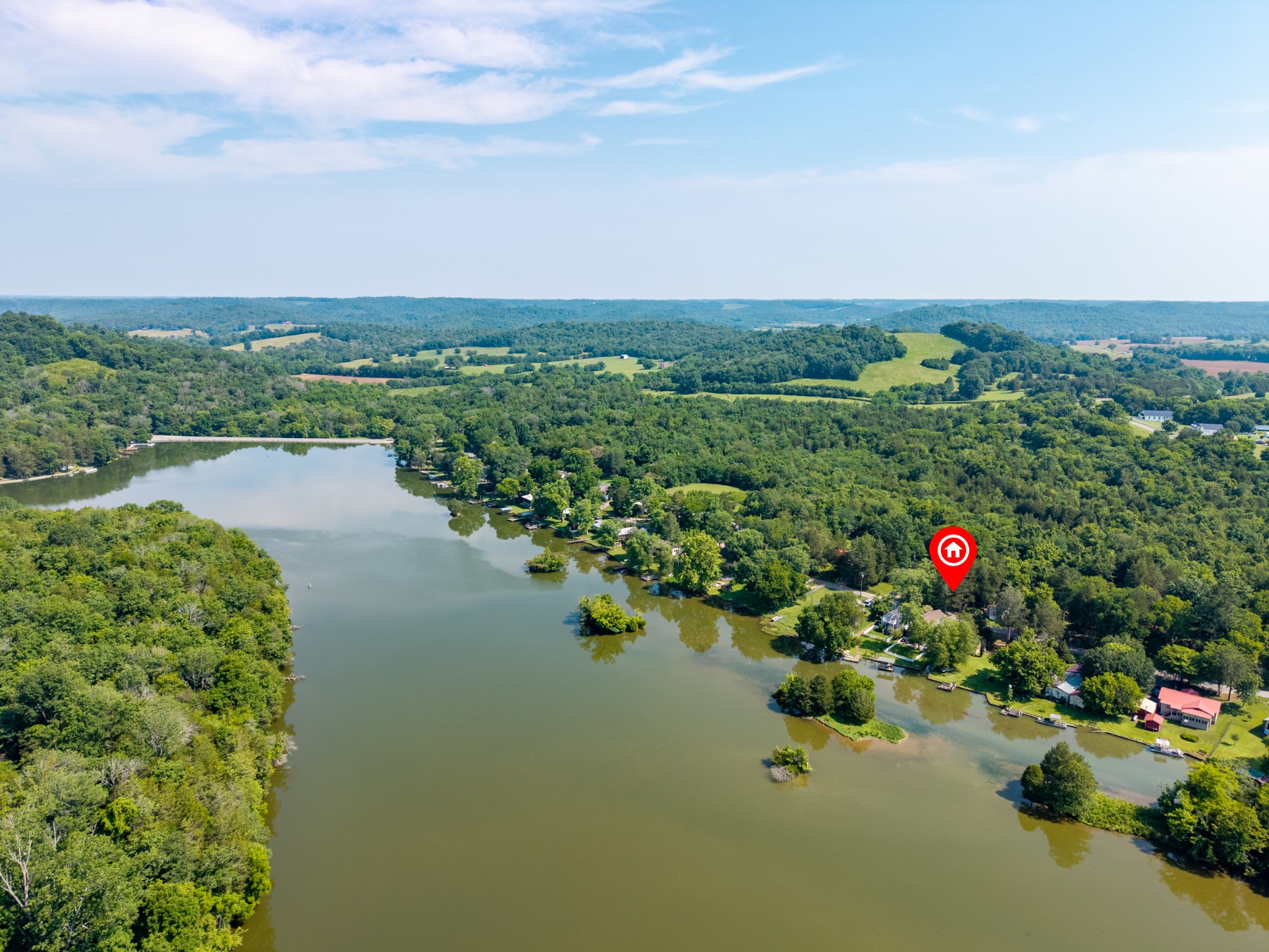 an aerial view of a house with a yard and lake view