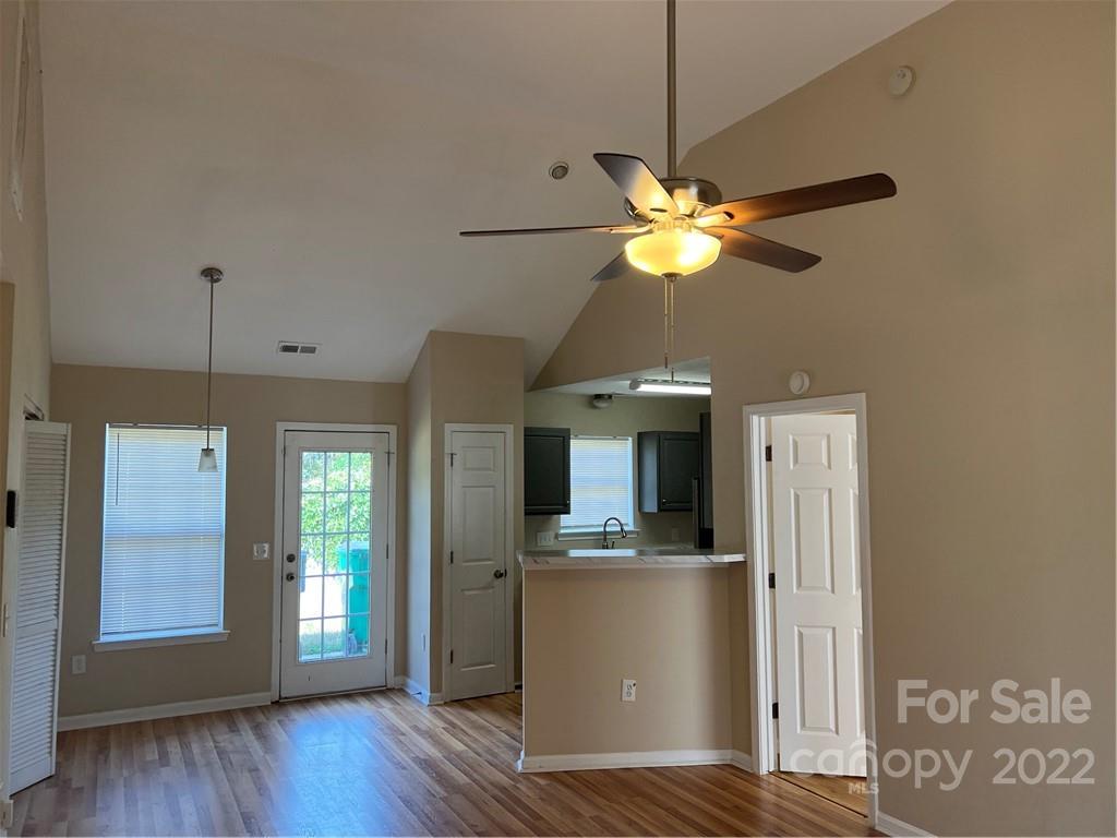 708 South Hoskins Road Charlotte, NC 28208 - Photo 3 of 16 a view of a kitchen with wooden floor and a ceiling fan
