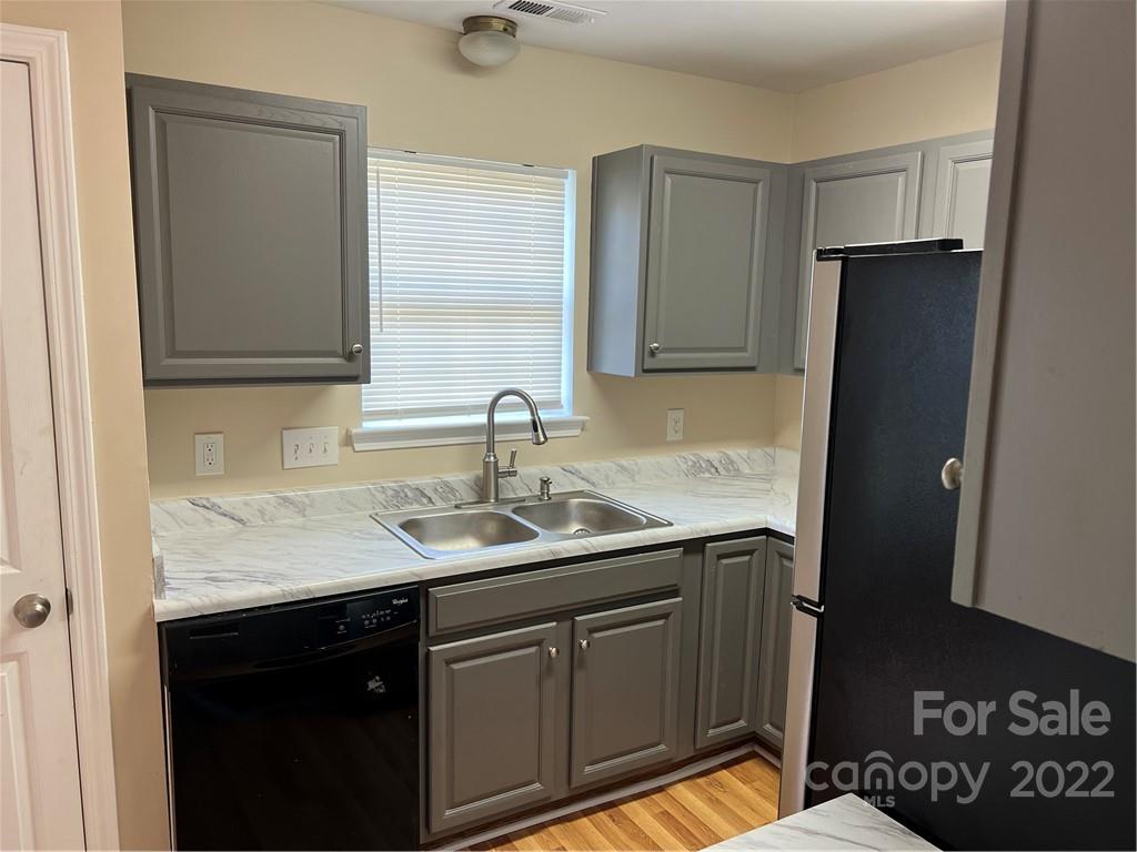 708 South Hoskins Road Charlotte, NC 28208 - Photo 5 of 16 a kitchen with a sink and a refrigerator