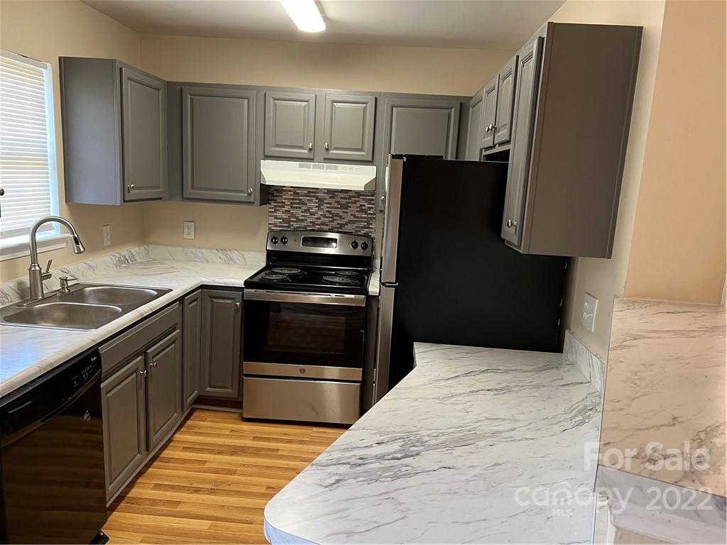 708 South Hoskins Road Charlotte, NC 28208 - Photo 6 of 16 a kitchen with granite countertop a refrigerator stove and sink