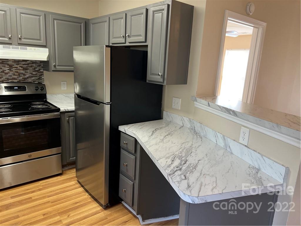 708 South Hoskins Road Charlotte, NC 28208 - Photo 7 of 16 a kitchen with stainless steel appliances granite countertop a refrigerator and a stove