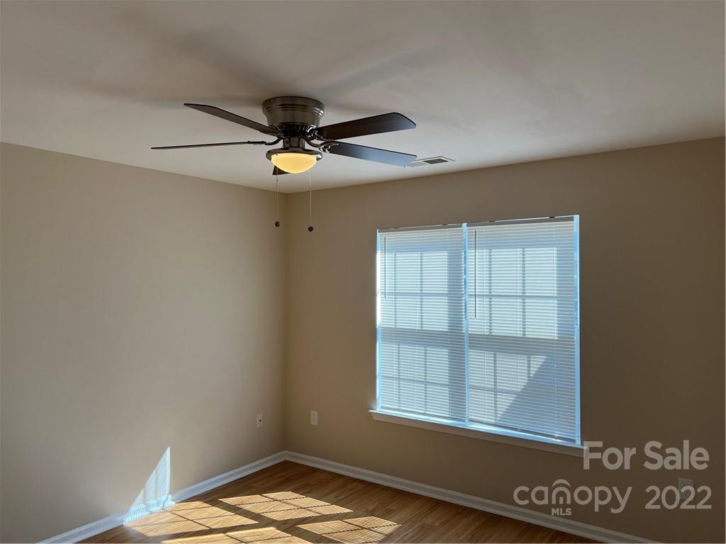 708 South Hoskins Road Charlotte, NC 28208 - Photo 8 of 16 an empty room with windows and ceiling fan