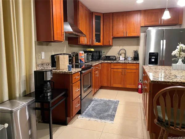 a kitchen with stainless steel appliances granite countertop a stove refrigerator sink and cabinets