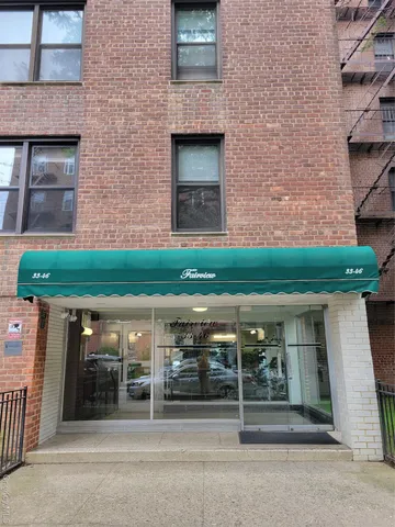 front view of a brick house with a small yard