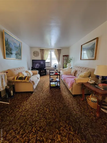 a spacious bedroom with a bed couch and a window