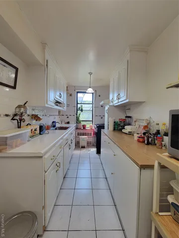 a kitchen with stainless steel appliances a sink stove and cabinets
