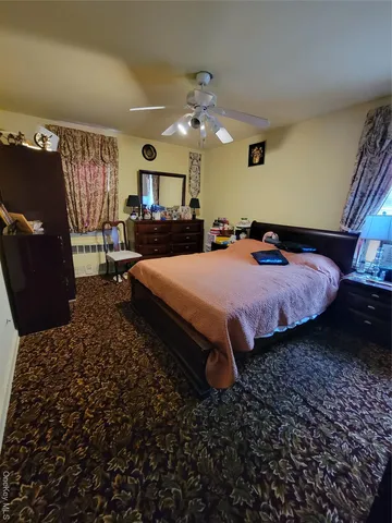a bed room with a bed window and a chair