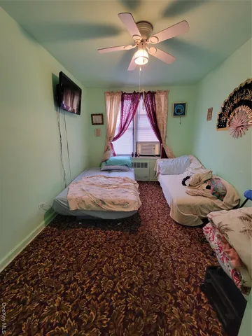 a bedroom with a bed window and a chandelier