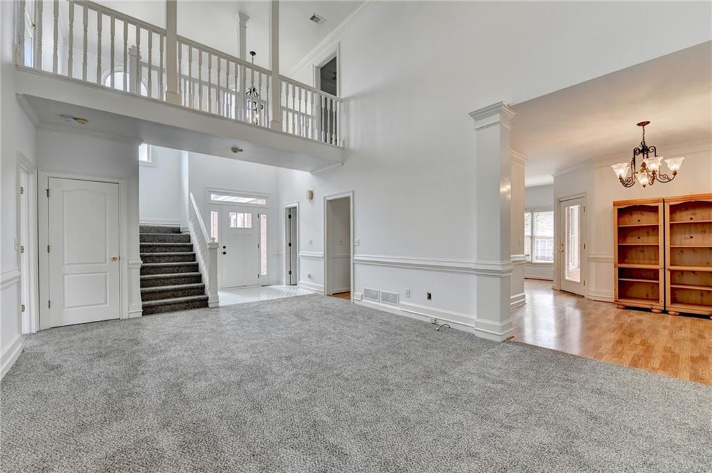 1005 Lewis Ridge Circle Lawrenceville, GA 30045 - Photo 11 of 74 wooden floor in an empty room with a staircase