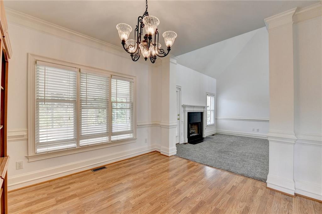 1005 Lewis Ridge Circle Lawrenceville, GA 30045 - Photo 15 of 74 a view of a livingroom with a chandelier fire place and windows