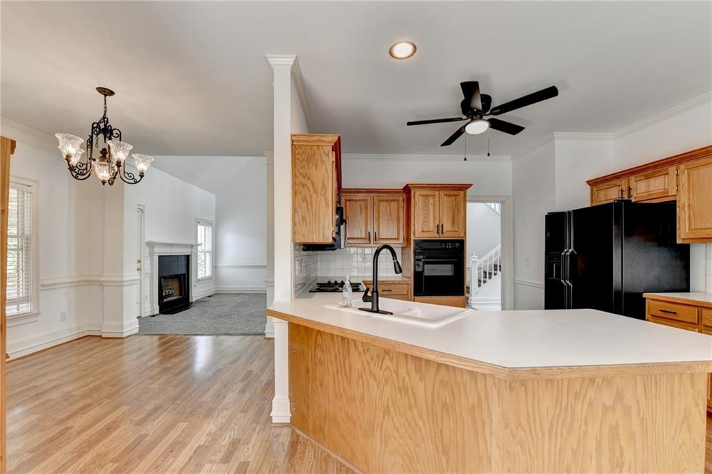1005 Lewis Ridge Circle Lawrenceville, GA 30045 - Photo 17 of 74 a room with a chandelier furniture and a flat screen tv