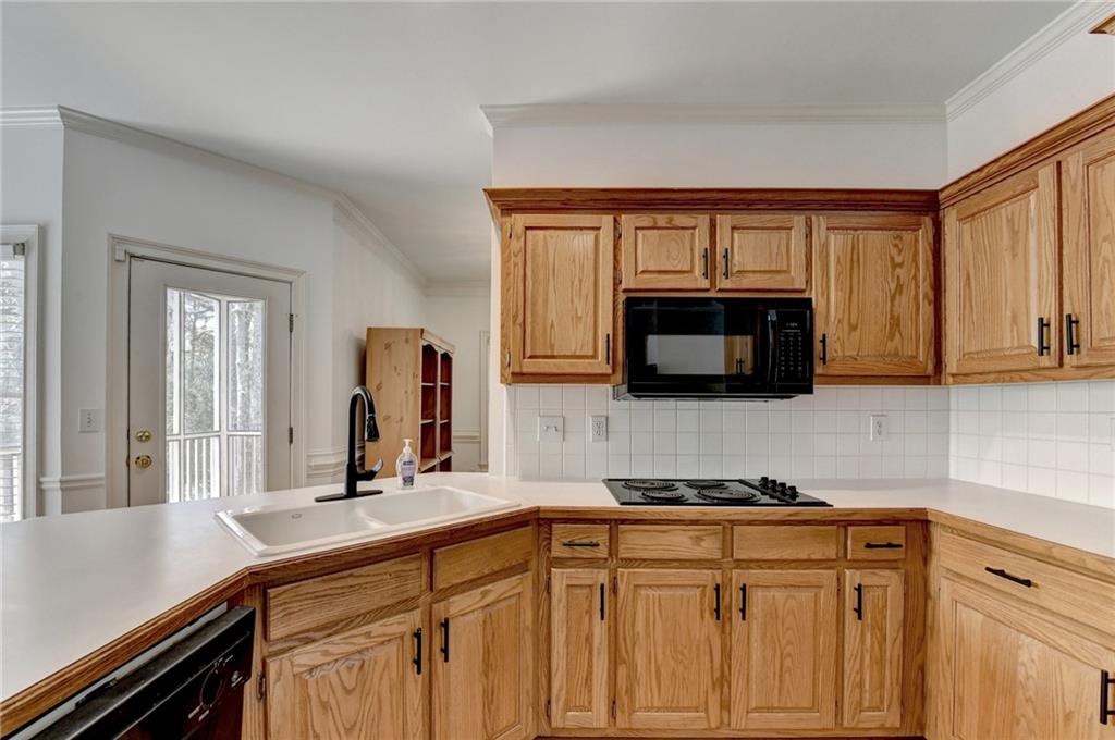 1005 Lewis Ridge Circle Lawrenceville, GA 30045 - Photo 20 of 74 a kitchen with stainless steel appliances granite countertop a sink and a microwave