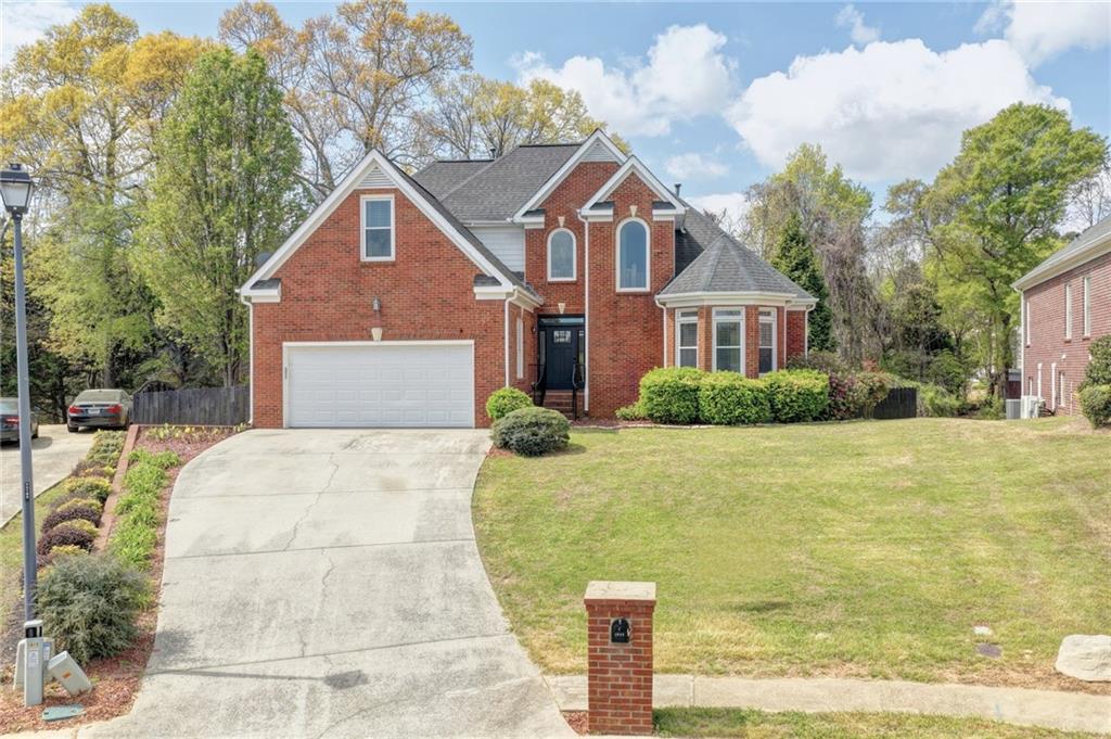 1005 Lewis Ridge Circle Lawrenceville, GA 30045 - Photo 2 of 74 a front view of a house with a yard