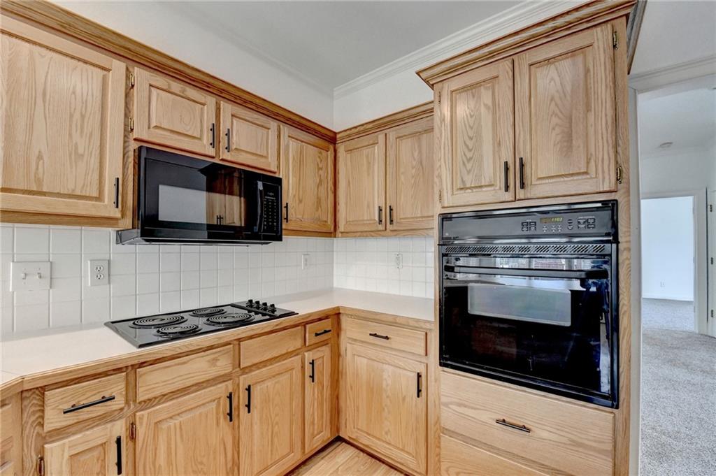 1005 Lewis Ridge Circle Lawrenceville, GA 30045 - Photo 21 of 74 a kitchen with granite countertop white cabinets stainless steel appliances and a sink