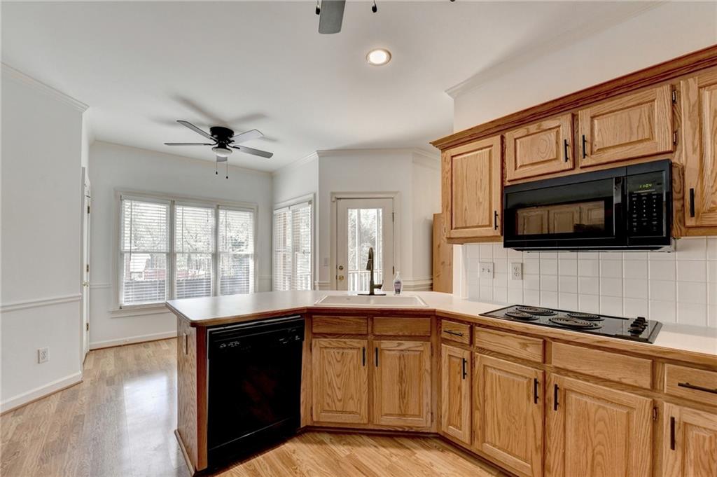 1005 Lewis Ridge Circle Lawrenceville, GA 30045 - Photo 23 of 74 a kitchen with stainless steel appliances granite countertop a sink stove and microwave