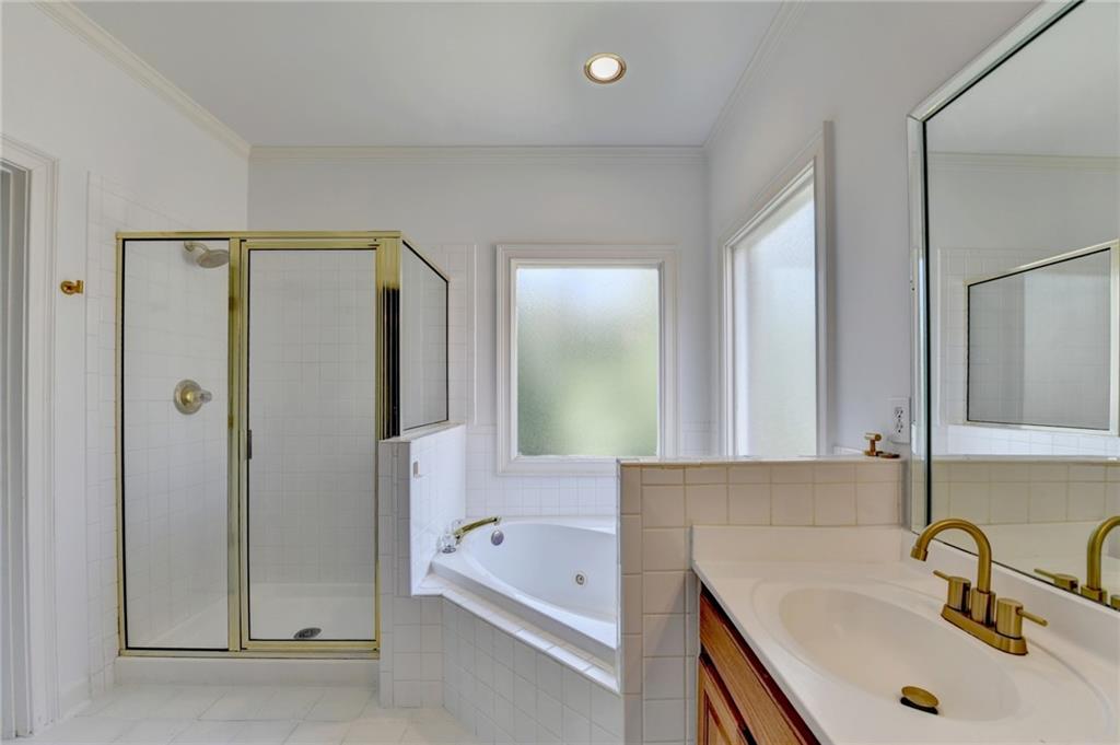 1005 Lewis Ridge Circle Lawrenceville, GA 30045 - Photo 32 of 74 a bathroom with a tub sink and mirror