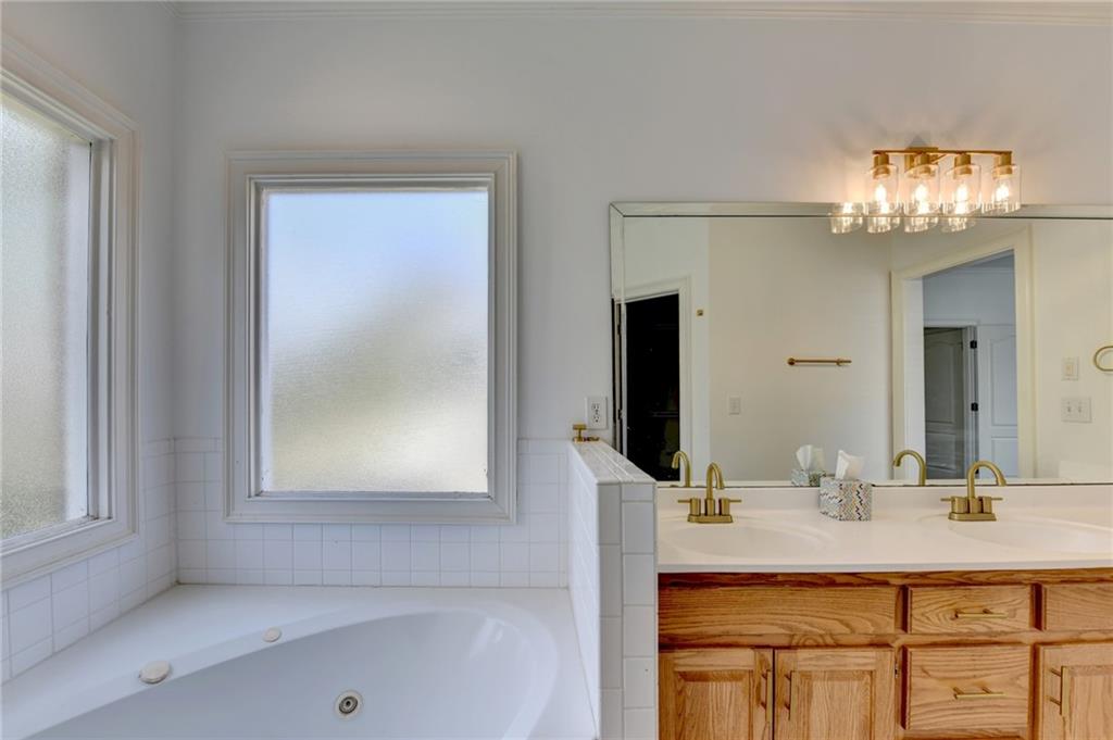1005 Lewis Ridge Circle Lawrenceville, GA 30045 - Photo 33 of 74 a bathroom with a sink and a mirror
