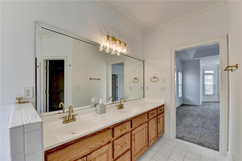 1005 Lewis Ridge Circle Lawrenceville, GA 30045 - Photo 34 of 74 a bathroom with a double vanity sink and a mirror