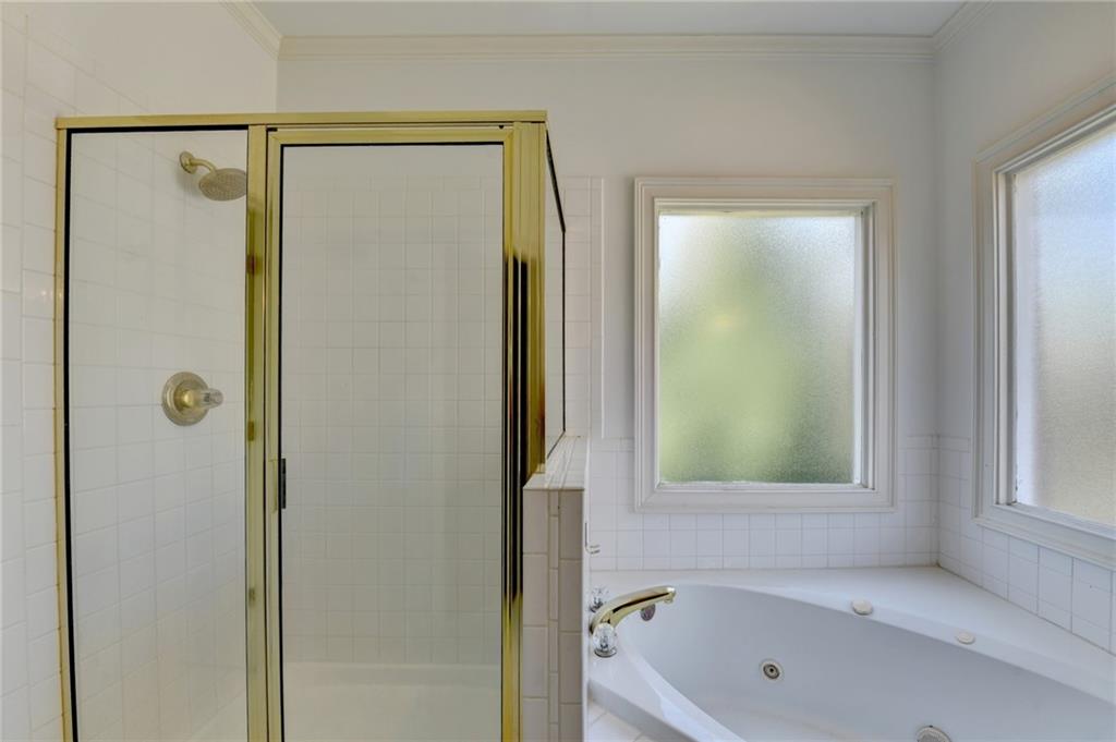 1005 Lewis Ridge Circle Lawrenceville, GA 30045 - Photo 35 of 74 a bathroom with a tub and a shower