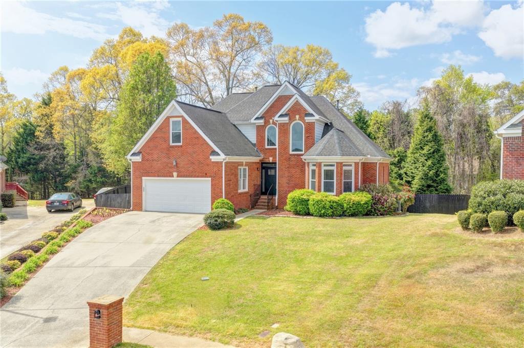 1005 Lewis Ridge Circle Lawrenceville, GA 30045 - Photo 4 of 74 a front view of a house with a yard